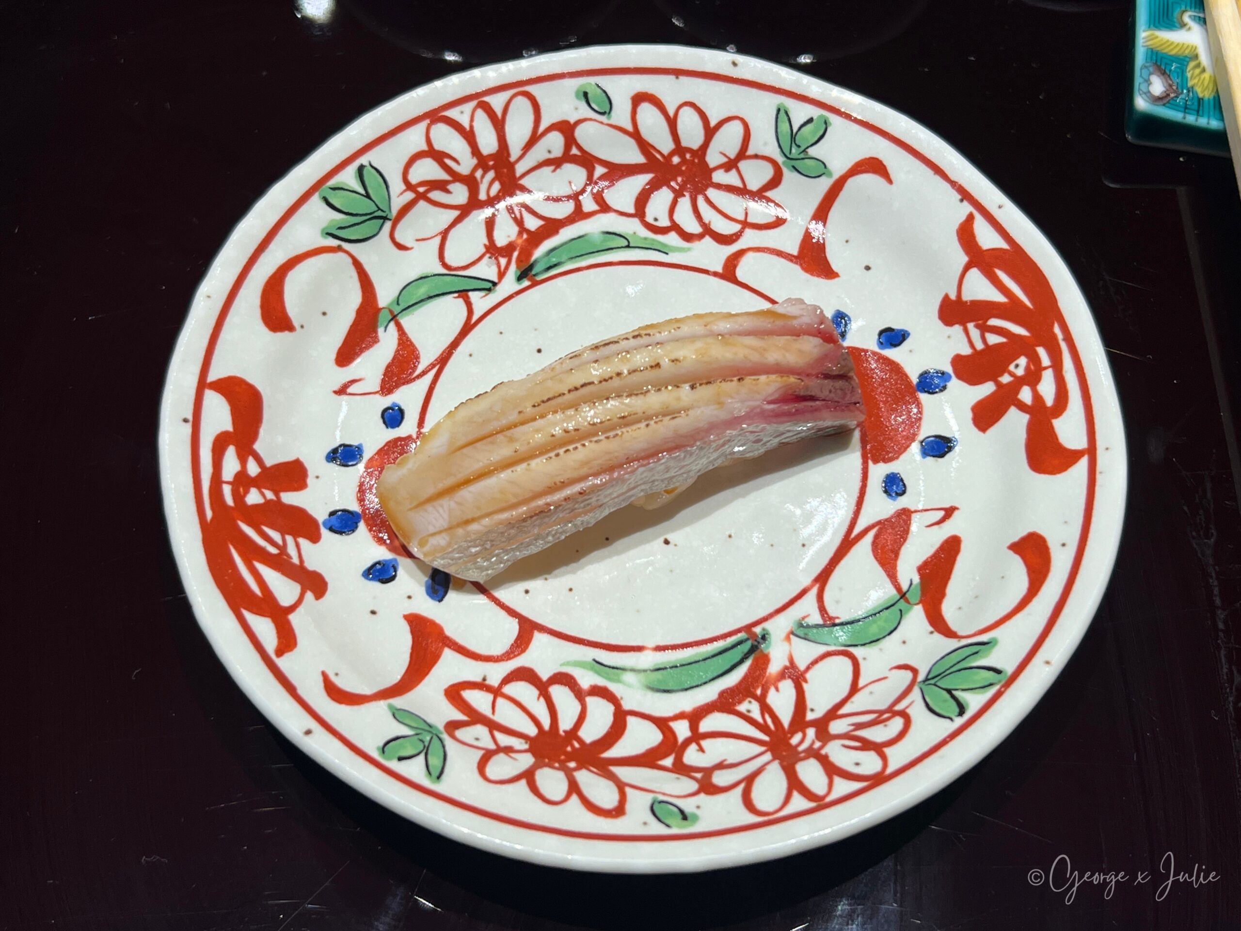 白干握壽司，白色脆Q貝肉盛在花紋小圓盤